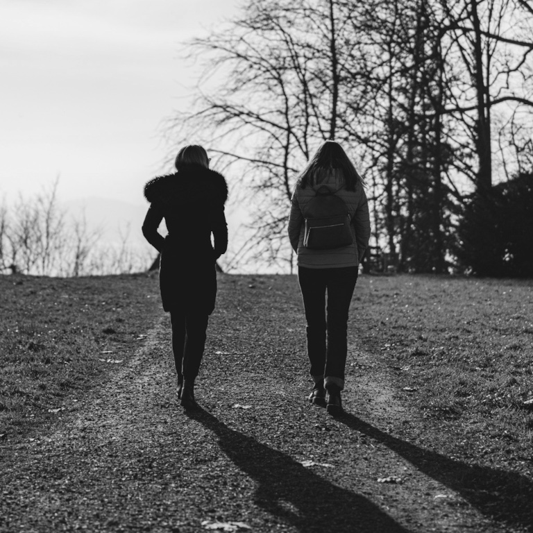 Two people walking and talking